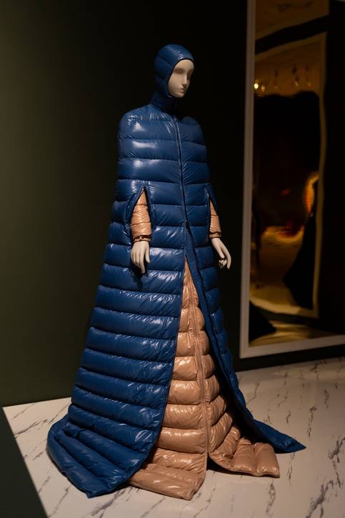The 2019 Moncler coat dress by Pier Paolo Piccioli honors Renaissance fashion in men's doublets, pleated in the same way as today’s puffer coats.